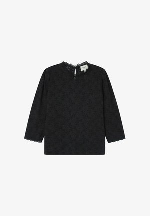 Haut noir à manches longues avec un motif de dentelle florale, encolure festonnée et poignets. Tissu léger avec une coupe décontractée et un dos en ras de cou.