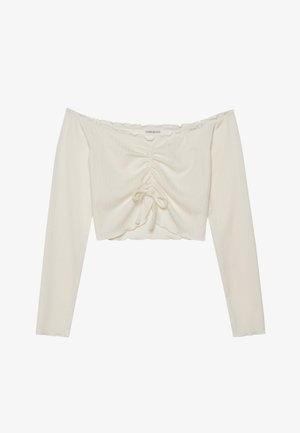 Kratka majica s otkrivenim ramenima od rebraste bež tkanine, s detaljem na šnuru sprijeda i dugim rukavima s valovitim rubovima.