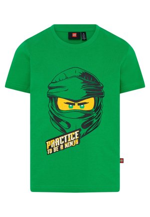 Grøn børne-t-shirt med grafisk illustration af et ninjaansigt og teksten "Øv dig i at være en ninja" på forsiden.