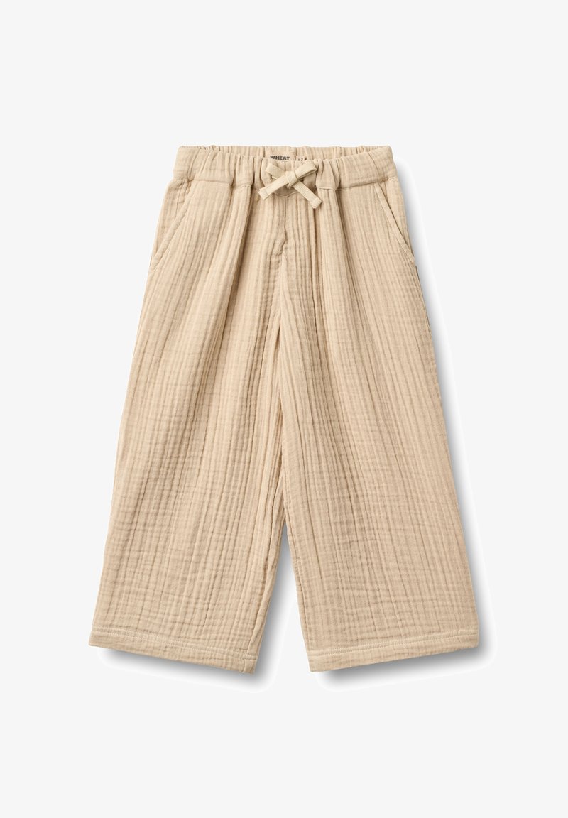 Pantalon beige à jambes larges en tissu de coton texturé, avec une taille élastique munie d'un cordon de serrage et des poches latérales.