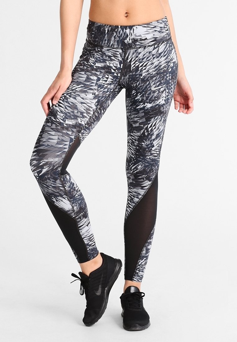 Black and gray patterned leggings with a high waistband, featuring mesh accents on the sides and a smooth, stretchy fabric composition.