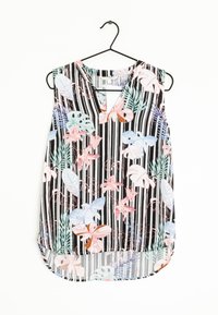 Ärmlös blus med blommönster i rosa, blått och grönt på en svart och vit randig bakgrund. V-ringad design, rundad nederkant.