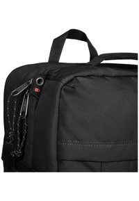 Black backpack featuring durable fabric, zippered compartment, and textured surface. Includes a top handle and adjustable straps.