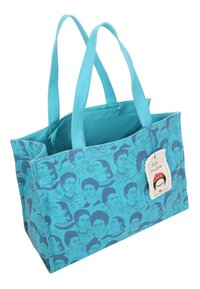 Sac en toile bleu avec un imprimé répétitif de visages stylisés. Le tissu est en coton avec une texture lisse. Inclut une étiquette avec une illustration de tête.