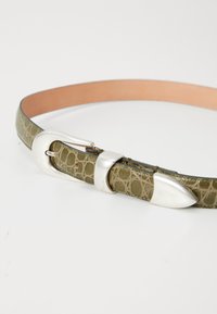 Ceinture en cuir vert avec une texture crocodile, dotée d'une boucle en métal argenté et d'accents, et d'une face inférieure lisse couleur beige clair.