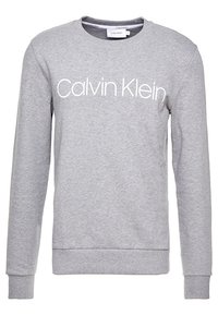 Felpa grigia realizzata in morbido misto cotone, caratterizzata da maniche lunghe, scollatura rotonda e logo bianco "Calvin Klein" sul davanti.