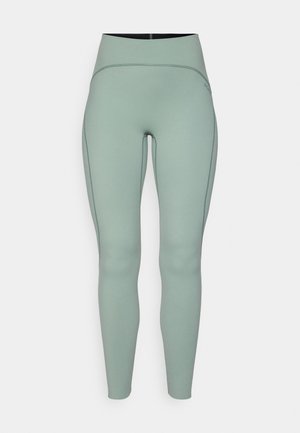 Leggings de cintura alta, verde-menta, feitos de um tecido liso e elástico com costuras em contraste. Apresentam uma silhueta elegante e ajustada ao corpo.