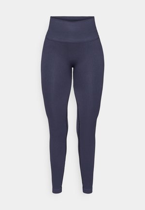 Marineblå ribbede leggings med høyt liv, figurnær design og en glatt tekstur, med subtile detaljer i sidesømmer.
