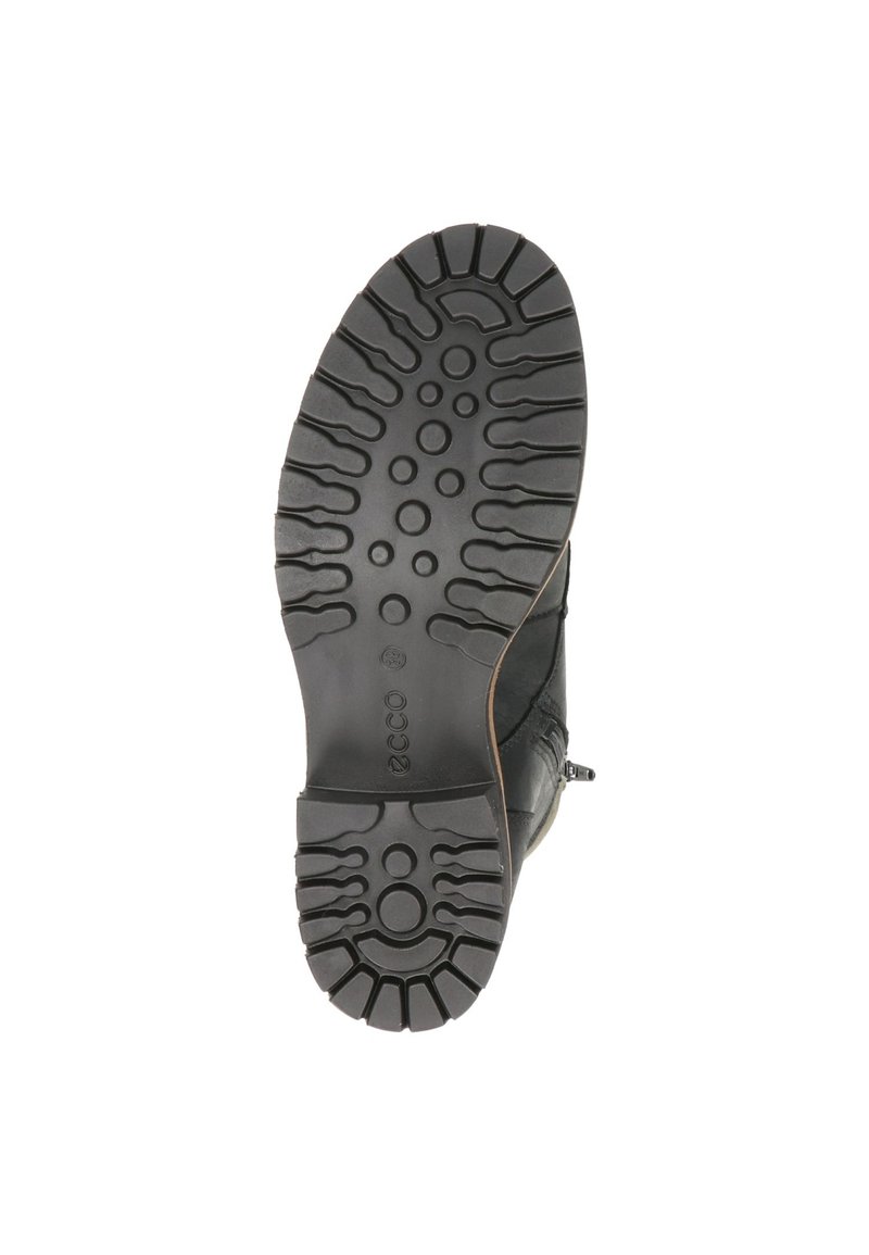 Czarna gumowa podeszwa z głębokimi bieżnikami, o zaokrąglonym kształcie i kontrastujących teksturach, zaprojektowana dla lepszej przyczepności i stabilności w różnych warunkach.