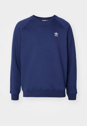 Sudadera de color azul marino hecha de tela suave, con cuello redondo, mangas raglán y un pequeño logo blanco de adidas en el pecho.
