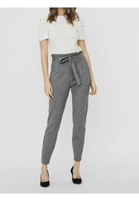 Gray, tapered trousers with a belted waist and side pockets. Textured fabric with a smooth finish, paired with a plain white top.