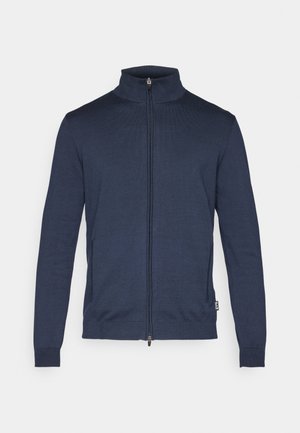 Marineblå zip-up sweater lavet af strikket stof, med høj krave, lange ærmer og sidelommer med ribbede manchetter og kant.
