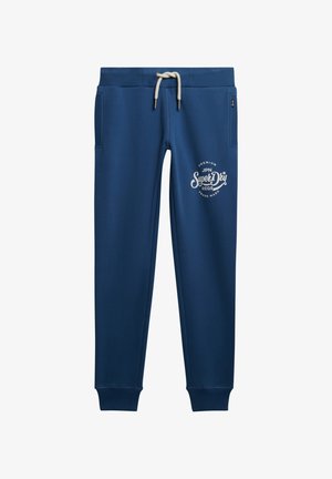 Pantalones de chándal azul marino hechos de tela suave, con una cinturilla elástica y cordón ajustable, además de dos bolsillos laterales. Logo impreso en la parte delantera.