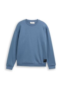 Niebieska bluza z miękkiego materiału, okrągłym dekoltem, długimi rękawami i ściągaczami na rękawach. Posiada małą czarną metkę na dolnym brzegu.