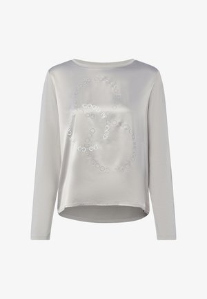 Vaaleanharmaa pitkähihainen paita pyöreällä kaula-aukolla ja etupuolella ympyränmuotoinen teksti, jossa lukee "DO GOOD BE GOOD".