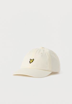 Off-white baseballkasket med en gul og sort fuglelogo broderet på fronten, vist mod en ensfarvet hvid baggrund.
