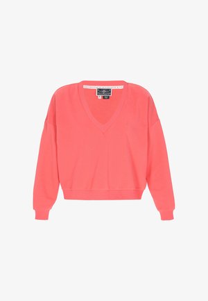 Coral pink V-neck sweater made of a soft, lightweight fabric. Features long sleeves and ribbed cuffs with a small logo accent on the chest.