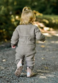 Beiger Woll-Overall mit elastischen Bündchen und Bund, kombiniert mit hellbeigen Stiefeletten mit strukturierter Sohle und hellblauen Akzenten.