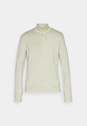 Light beige zip-up jacket with a high collar, long sleeves, and side pockets, made from a soft, textured fabric and featuring a minimal design.