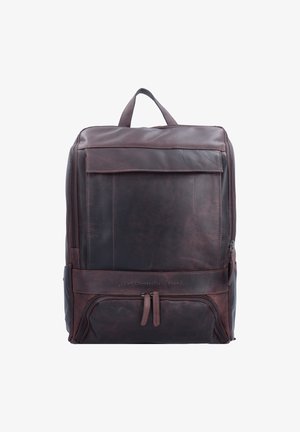 Brown leather backpack with a smooth surface, front zip pocket, and top handle. Features a contrast panel and subtle branding.