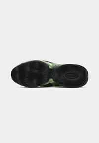 Green upper with a glossy finish, featuring black rubber outsole with wavy tread patterns. Design includes cutouts for ventilation.