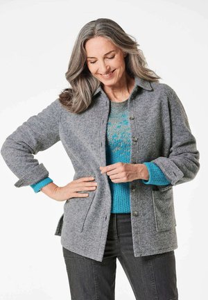 Gray wool blend button-up jacket with a collar, featuring pockets, rolled cuffs, and layered over a turquoise patterned sweater.