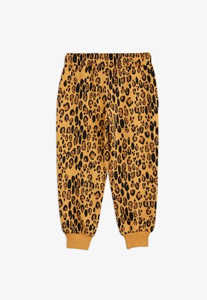 Trenerke s printsom leoparda u tkanini žute-narančaste boje, s crnim točkama, elastičnim strukom i suženim manžetama na gležnjevima.