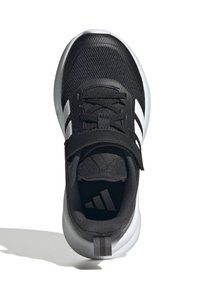 Chaussure de sport noire avec une tige en maille, accents blancs en trois bandes, lacets et une sangle Velcro. Présente une semelle texturée et un détail de logo.