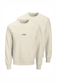 Deux sweat-shirts beige à col ras du cou, arborant un petit logo noir "JJ Studios" sur la poitrine. Confectionnés en tissu doux.