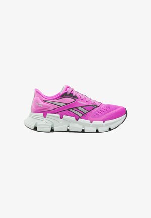Bright pink Reebok running shoe with mesh upper, black and gray side stripes, thick segmented white sole, and laces.