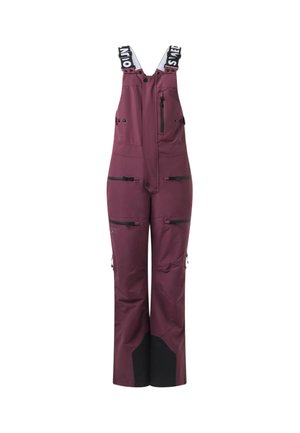 Salopette bordeaux longue avec accents noirs, multiples poches zippées et bretelles réglables noires et blanches.