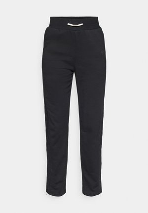 Black athletic joggers with a soft texture, featuring a ribbed waistband and side stripes with a zipper at the hem for adjustable fit.