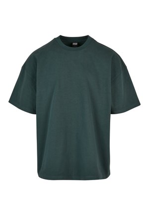 Mørkegrøn oversized bomulds t-shirt med rund halsudskæring, løse ærmer og en lige forneden. Minimalistisk design, blød tekstur.