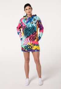 Colorful oversized hoodie with a mix of animal prints, including zebra and leopard, featuring a hood and side pockets. Made from lightweight fabric.
