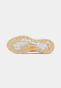 Rubber athletic shoe outsole with a textured, honeycomb pattern in tan and white, featuring a Vibram logo and contrasting red upper section.
