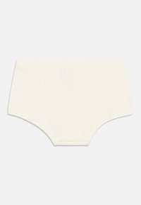 Puuvillased aluspüksid heleses toonist, ilma õmblusteta kujundusega. Pehme tekstuur ja elastne vöökoht. Lihtne, klassikaline kuju, ilma nähtavate mustrite või kaunistusteta.