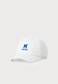 White baseball cap made of cotton, featuring a blue embroidered butterfly logo and "HUGO" text on the front. Curved visor design.