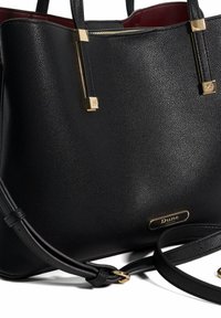 Black textured leather handbag with gold-tone hardware. Features dual top handles and an adjustable shoulder strap. Lined interior.