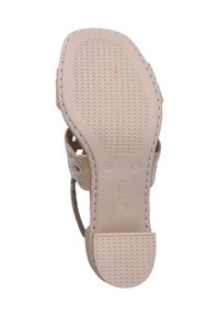 Sandal avec une semelle plate, base en caoutchouc beige clair, strass décoratifs sur les brettelles et semelle texturée pour une bonne adhérence. Taille 37.