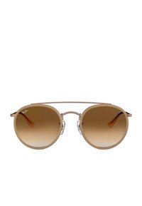 Occhiali da sole in stile aviatore con lenti marroni sfumate, montatura trasparente e dettagli metallici. Presentano un doppio ponte e astine curve.