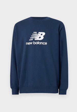 Granatowa bluza z długim rękawem i okrągłym dekoltem, z dużym białym logo New Balance i tekstem na środku przodu.