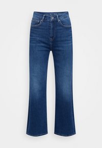 Jeans blu svasati a vita alta in denim, con cinque tasche, chiusura con zip e una sottile texture sbiadita.