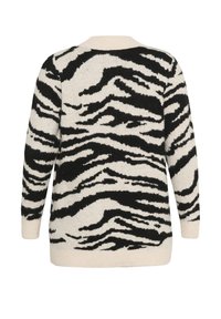 Juoda ir balta mezginė megztinis su zebra raštu, turintis ilgus rankoves, apvalų iškirpimą ir minkštą tekstūrą. Lygus apvadas ir rankogaliai.