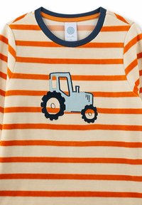 Cream and orange striped long-sleeve shirt with navy collar and a blue tractor graphic on the front center.