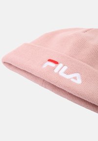 Cappello in maglia rosa con risvolto, caratterizzato dal logo "FILA" ricamato in bianco con un accento rosso. Tessuto morbido e vestibilità aderente.