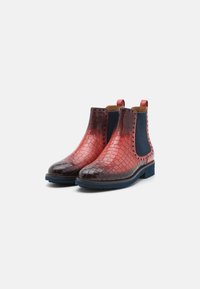 Stivali Chelsea rosso e nero con texture in coccodrillo, pannelli laterali elasticizzati e suola in gomma blu. Presentano linguette sul retro per una facile vestibilità.