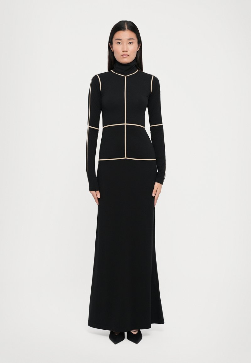 Black long-sleeve dress in stretchy fabric, featuring a high neckline and geometric cream-colored seams that outline the silhouette.