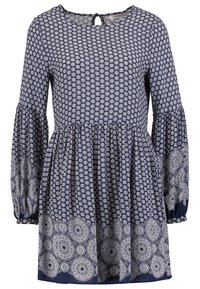 Robe bleu marine avec manches longues bouffantes, ornée d'un motif floral blanc. Elle présente une jupe évasée et un détail dos en clé.