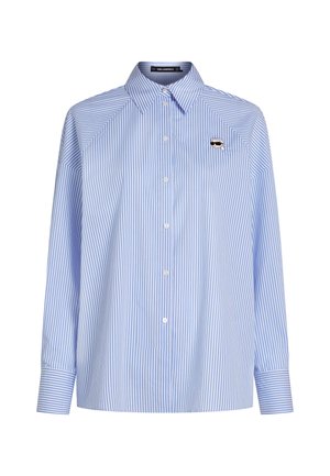 Camicia a maniche lunghe a righe verticali azzurre e bianche con bottoni frontali e piccolo volto ricamato con occhiali da sole sul petto sinistro.