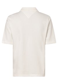 Polo à manches courtes couleur crème, en coton doux. Doté d'un col et d'un accent triangulaire à l'arrière. Design simple et classique.